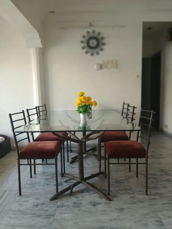 Six-seater glass-top dining table in the furnished flat, City Light, Surat